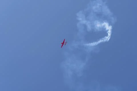 Vintage biplane does loop stunt with smoke trails. airplane air show Stock Photos
