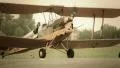 Vintage biplane with spinning propeller steering on ground HD Footage