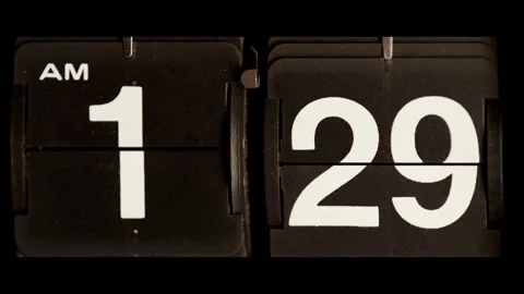 Vintage black flip clock changing time in close up Stock Footage 329673823