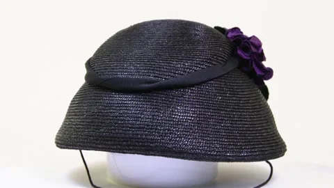 Vintage black straw hat with a artificial violets 1950s Stock Footage 313587228