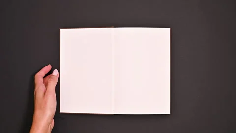 Vintage Book Magic: Woman's Creative Page Turn Stock Footage 254874476
