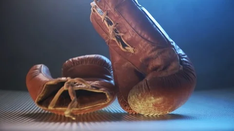 Vintage Boxing Gloves Falling On The Abstract Surface. Stock Footage 124252202
