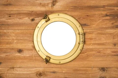 Vintage brass porthole in wooden wall Stock Photos
