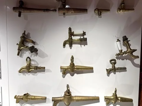 Vintage brass spigots displaying evolution of tap design Stock Photos