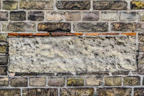 Vintage brick wall pattern background with rectangle of cement in the middle. 스톡 사진