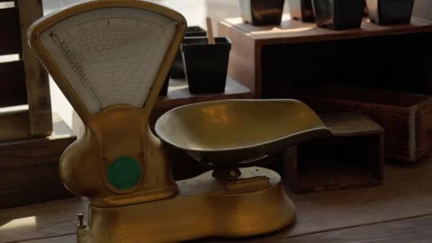 Vintage bronze kitchen scale in rustic wooden interior Stock Footage 312072869