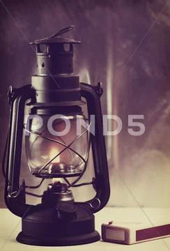 Vintage burning lantern against grunge backgrounds. abstract still life Stock Photos