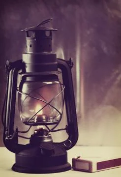 Vintage burning lantern against grunge backgrounds. abstract still life Stock Photos