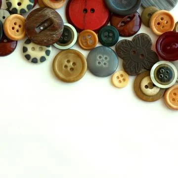 Vintage button collection bordering white background Stock Photos