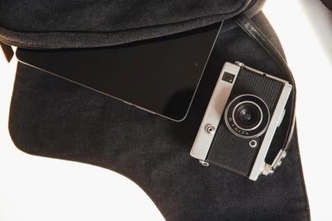 Vintage camera and tablet computer on a dark bag Stock Photos