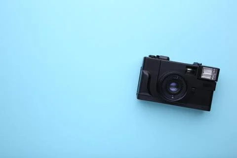 Vintage camera on blue background. Old photo camera on background Stock Photos