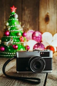 Vintage camera on Christmas background with decorations and Christmas tree Stock Photos