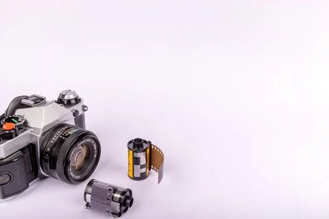 A vintage camera placed on the left side, accompanied by 35mm film rolls, s.. Stock Photos