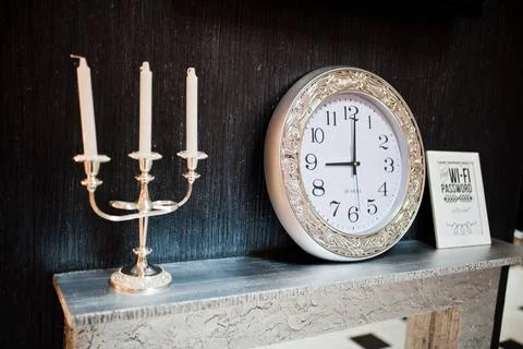 Vintage candlestick with silver clock at 9 am Vintage candlestick with sil... Stock Photos