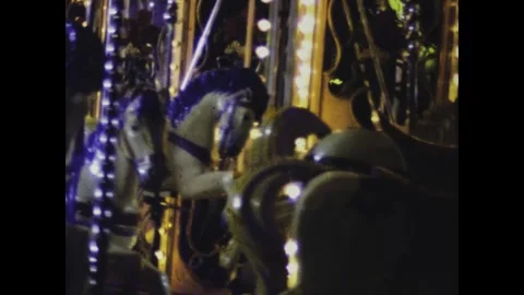 Vintage carousel with its lights shining bright spins in the night in paris.. Stock Footage 291038676