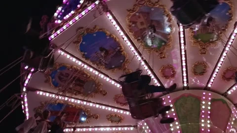 Vintage Carousel Swing Ride Rotating At Night With Bright Pink Lights Stock Footage 344597766