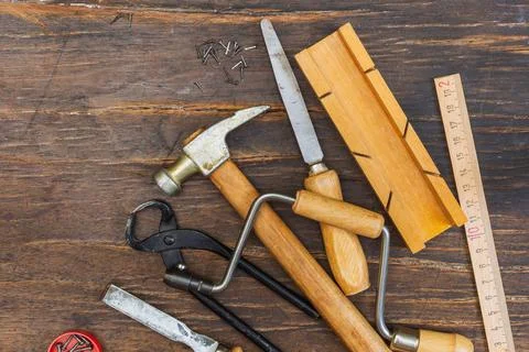 Vintage carpentry tools on a dark rustic wood background. Overhead, close-up Stock Photos