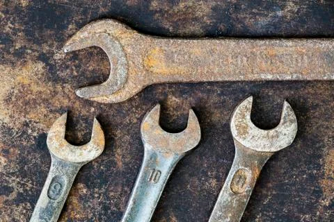 Vintage carpentry tools, different size wrenches on grunge background Stock Photos