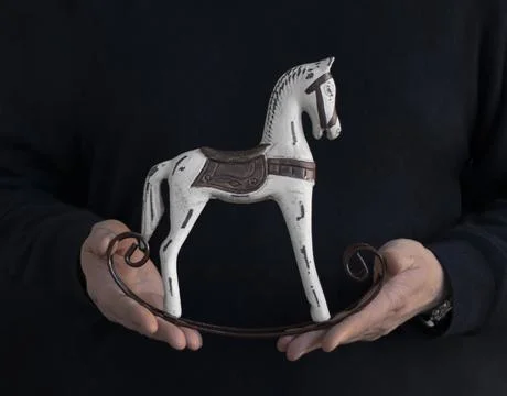 Vintage children's toy horse in hands Stock Photos