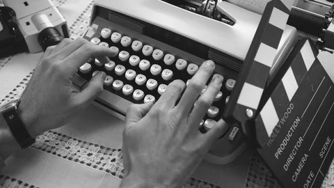 Vintage Cinematographer Typing Script on Typewriter Machine Black White Stock Footage 108563142