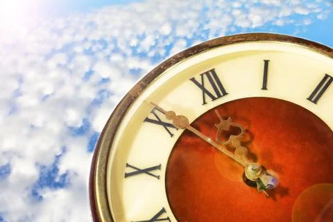 Vintage clock face on cloudy sky background. Stock Photos