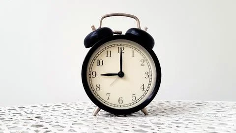 Vintage clock on table isolated on white background with copy space Stock Photos