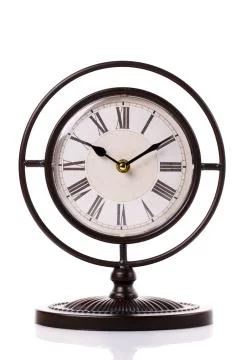 Vintage clock on the white surface background Stock Photos