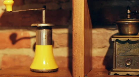 Vintage coffee grinders of different style and colors on a bricky background Stock Footage 65561910