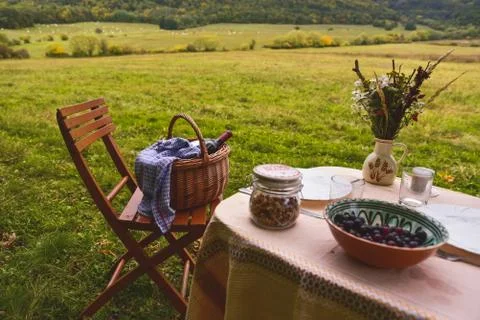 Vintage colored photo. Table prepared for lunch in autumn nature, picnic Stock Photos