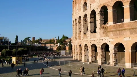 Vintage colored view of old coliseum facade with people,enjoy rome city wonders Stock Footage 129299702