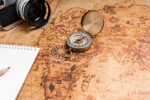 Vintage Compass and camera on map for travel planning Stock Photos