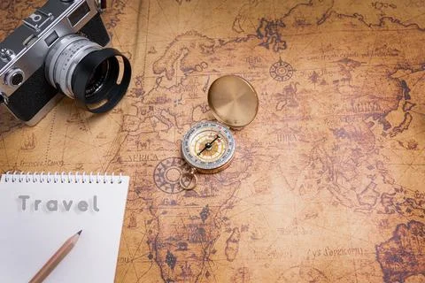Vintage Compass and camera on map for travel planning Stock Photos