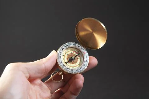 Vintage compass on a dark gray background, close - up Stock Photos