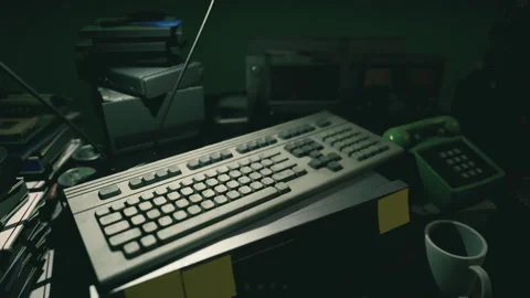 Vintage computer equipment on a cluttered desk in dimly lit room Stock Footage 294096722