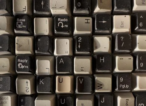 Vintage computer keyboard keys with worn letters symbols and dust texture. .. Foto stock