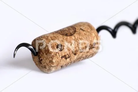 Vintage corkscrew with cork on a white background. Stock Photos