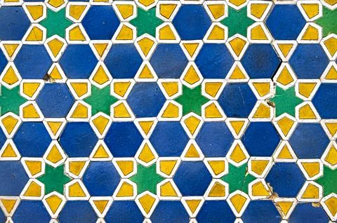 Vintage cracked tile with geometric arabic pattern on the mosque wall Stock Photos