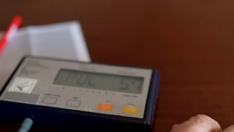 Vintage device at the table, elderly man measuring blood pressure and pulse Stock Footage 145684393