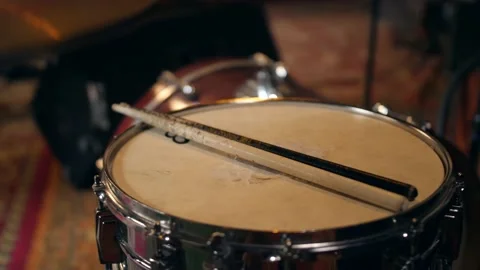 Vintage drumsticks lie on an old school drum. close-up Stock Footage