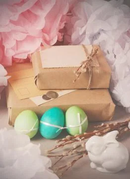 Vintage Easter still life with painted eggs, gift boxes in packaged in kraft Stock Photos