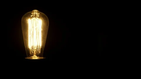 Vintage Edison bulb flickering in the dark. Retro lamp turning on. Stock Footage 102716559