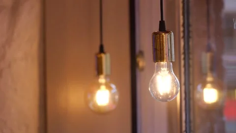 Vintage edison style light bulbs hanging and flickering in warm interior se.. Stock Footage 333153180