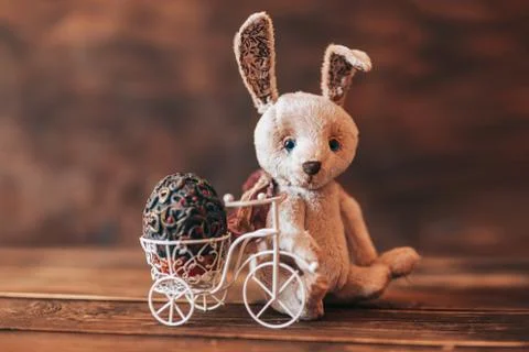 Vintage egg in Easter bice, Rabbit sitting near bicycle Stock Photos