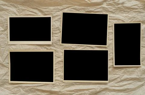 Vintage empty photo frames on crumpled paper background Stock Photos