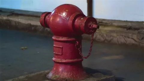 A vintage fire hydrant with peeling red paint stands by the road in Bangkok  Stock Footage 308869898