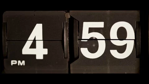 Vintage flip clock changes from four fifty nine pm Stock Footage 329667726