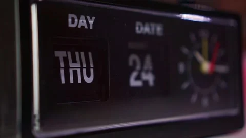 Vintage flip clock with day and date display, retro timepiece in dark room Stock Footage 344432115