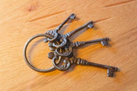 Vintage forged keys on fixed metal ring set with four old key shapes. Stock Photos