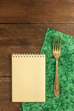 Vintage fork and notepad for copyspace, overhead shot Stock Photos