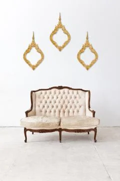 Vintage frame and sofa in white room Stock Photos
